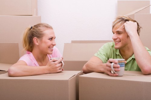 Student moving boxes and furniture in a Bow residential street