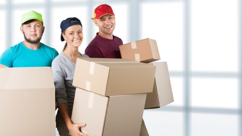 Moving van and packed boxes for a Bow relocation