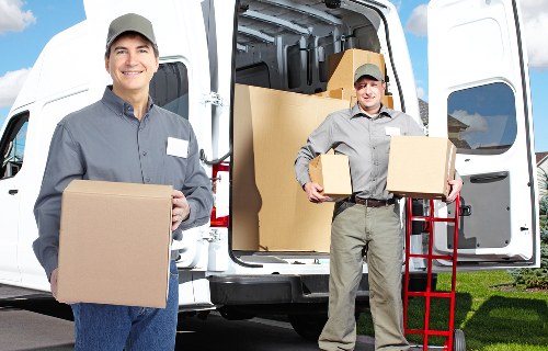 Packed office furniture and equipment ready for transport in Bow